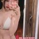 Attractive woman in white bikini taking a selfie. KL Escort Outcall.