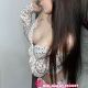 Attractive Malaysia escort girl in white top and shorts.