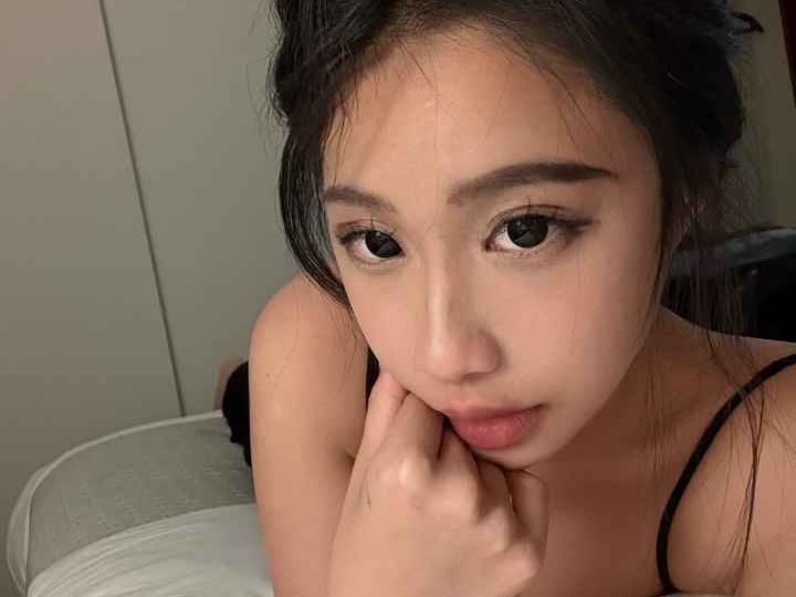 Attractive Malay woman relaxing in bed. Girl Malay Escort.