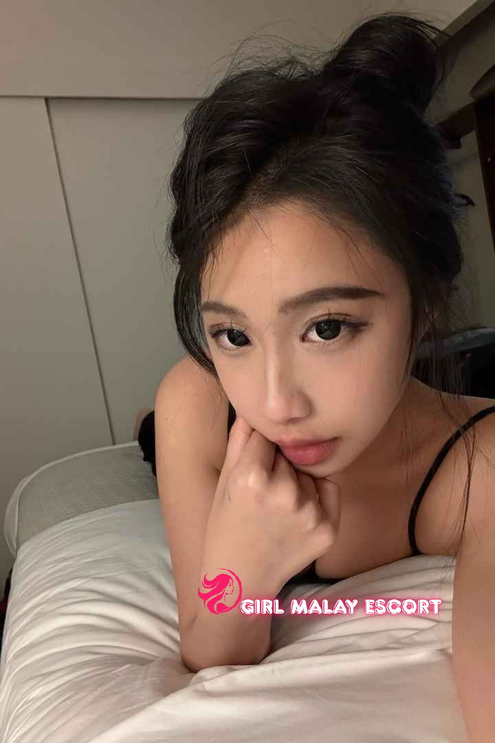Attractive Malay woman relaxing in bed. Girl Malay Escort.