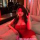 Attractive woman in red dress at hotel. Hotel escort services.