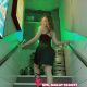 Attractive Malay woman in a red dress descending a staircase. KL escort.