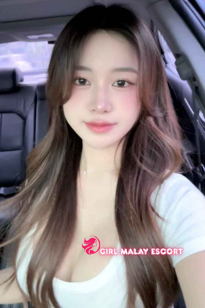 Attractive Malay woman in a white top. Girl Malay Escort.