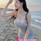 Attractive woman in grey dress on a beach. Kuala Lumpur escort.