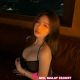 Attractive woman in a black dress, hotel setting. Booking escort services.