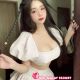 Attractive Kuala Lumpur escort girl in elegant white outfit.