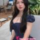 Celine, attractive KL escort, in a navy pinstripe dress. 5-star hotel outcall.