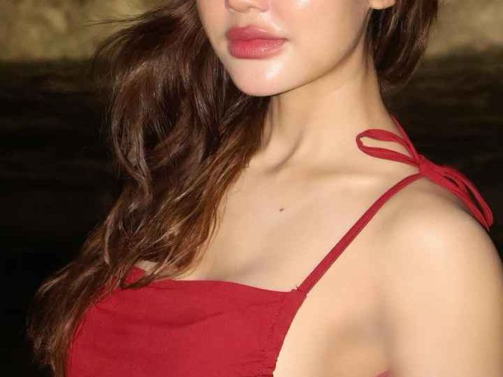Attractive Malay woman in a red dress. Girl Malay Escort.