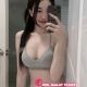 Attractive young woman taking a selfie in a bathroom, wearing a gray Calvin Klein bra and underwear. KL Escort Outcall.