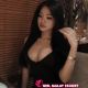 Attractive woman in black dress at a restaurant. Hotel escort booking service.
