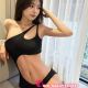 Attractive woman in a black one-shoulder swimsuit. Kuala Lumpur escort.