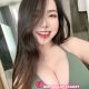 Attractive KL call girl in green bikini top.