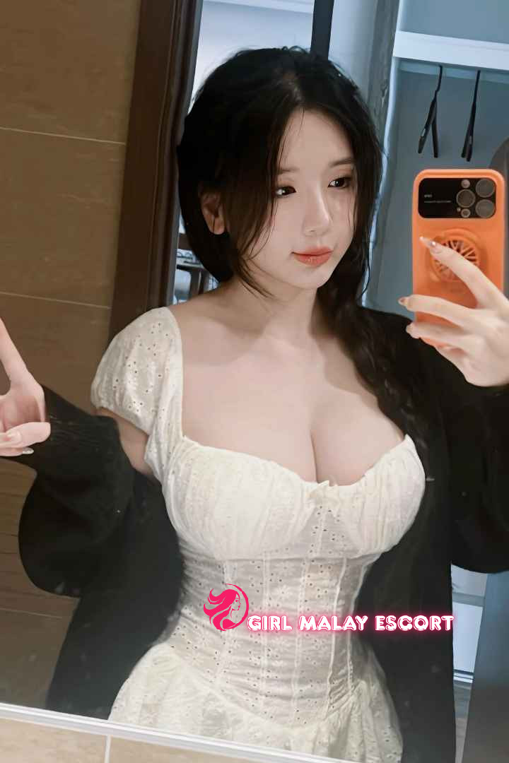 Attractive Malay woman in white dress. Girl Malay Escort.