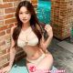 Attractive woman in a white bikini by a pool. Malaysia escort service.