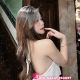 Attractive woman in white dress, available for hotel escort booking services.