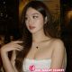 Attractive young woman in white top. Hotel escort booking service.