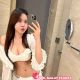 Woman in white lingerie taking a selfie in a bathroom. Malaysia escort service.