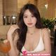 Attractive woman in white top at restaurant. Hotel escort booking service.