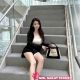 Attractive young Chinese woman sitting on stairs with a Balenciaga bag. Local Chinese escort.