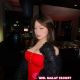 Attractive woman in red dress at a bar. Hotel escort services.